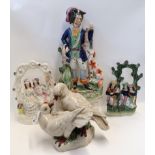 Three Staffordshire figure groups and an antiqued ceramic group of doves Condition Report: Available