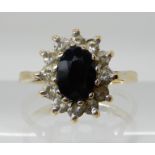A yellow metal sapphire and clear gem cluster ring size M, weight 2.5gms Condition Report: Available