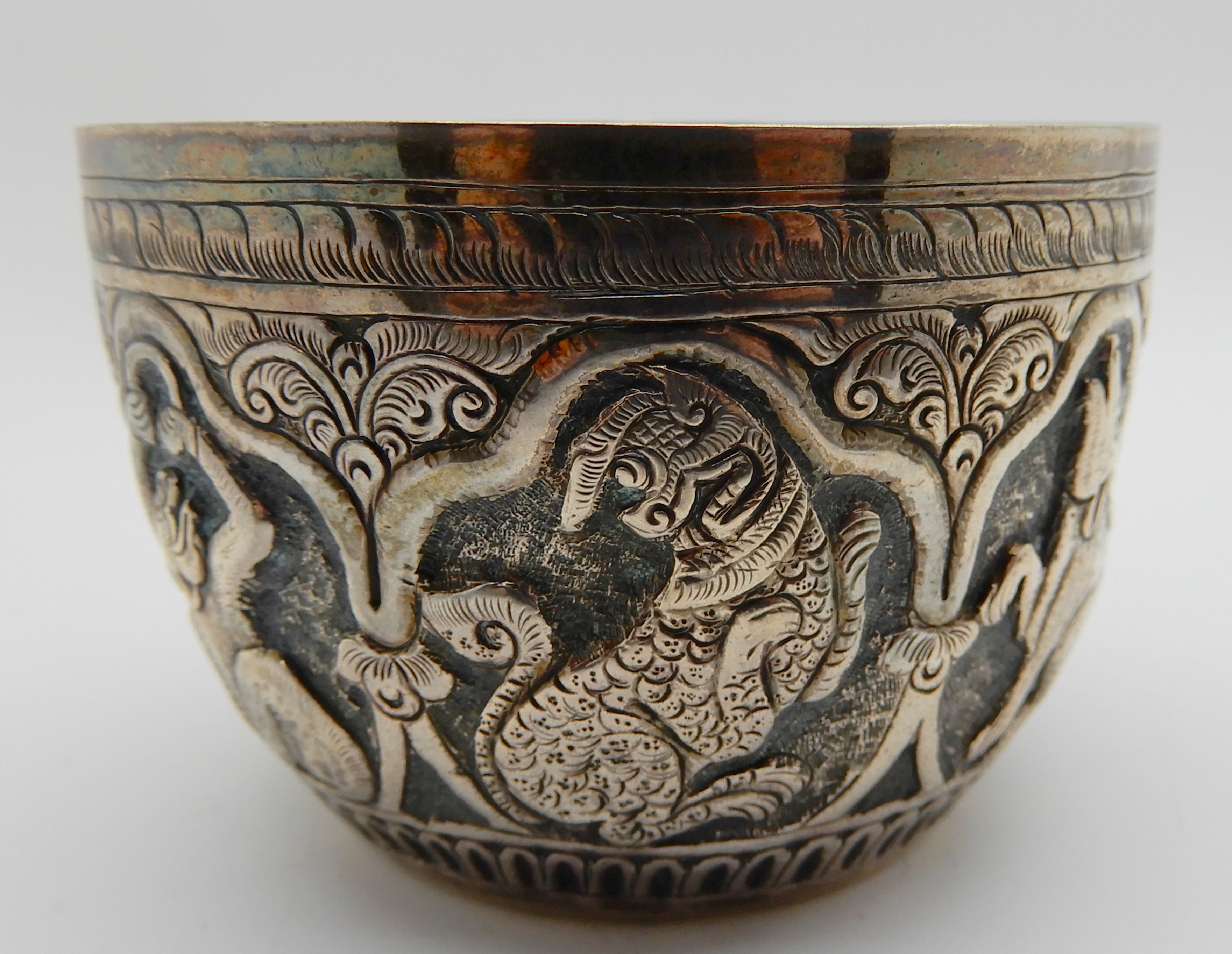 A lot comprising a Burmese white metal bowl, two napkin rings and a circular snuff box Condition - Image 3 of 6