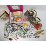 A collection of vintage costume jewellery to include Lisner, a Good times scarf watch, silver charms