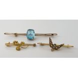A yellow metal three nugget brooch formed into a shamrock design, a 9ct blue gem set bar brooch