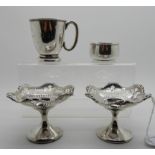 A lot comprising a pair of Calcutta silver bon bon dishes (weighted), a Christening mug and a salt