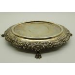 A silver teapot stand, oval with shell motifs on four paw feet, 18cm x 15cm, 293gms Condition