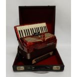 A German Weltmeister accordion in pearl red with case Condition Report: Available upon request