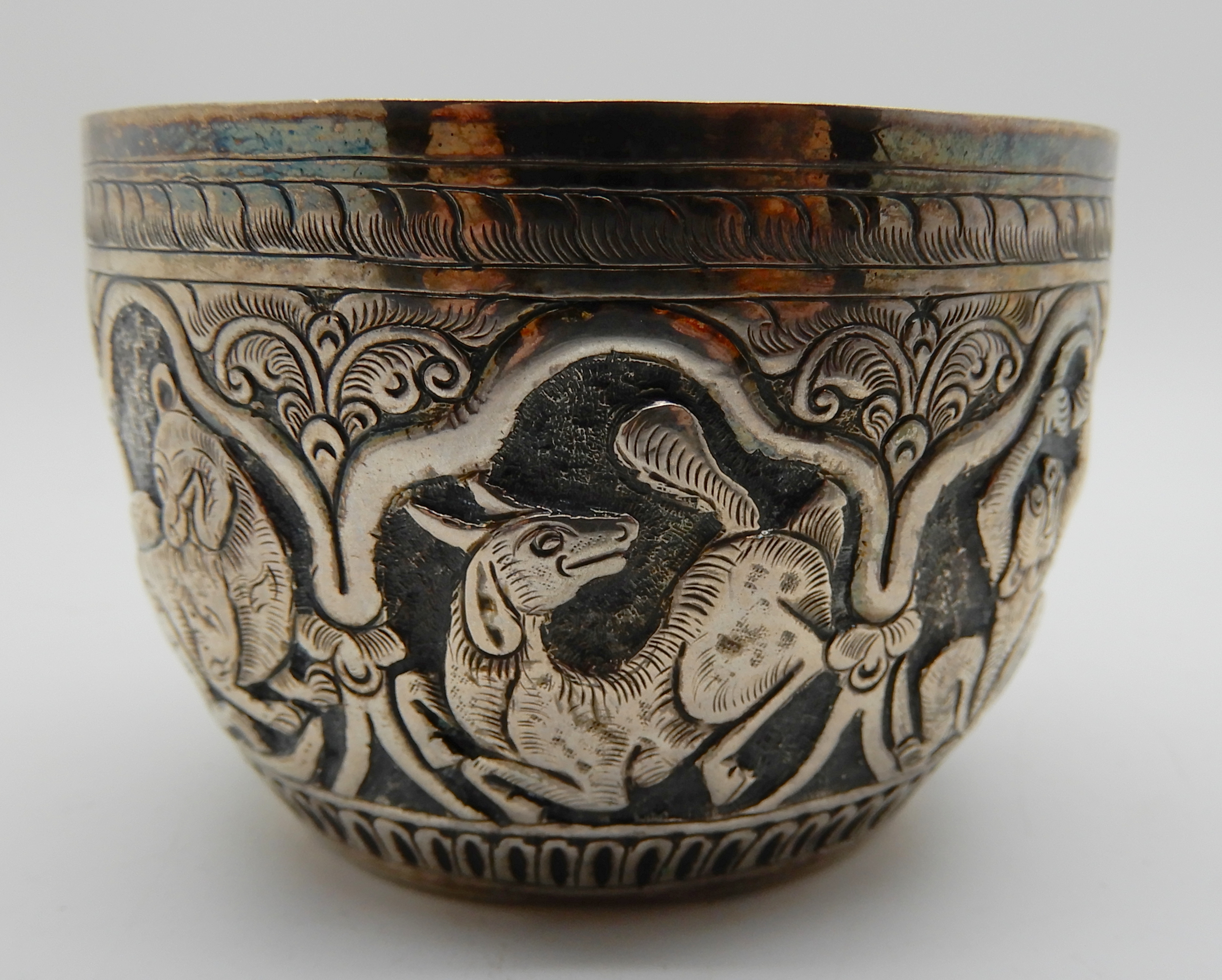 A lot comprising a Burmese white metal bowl, two napkin rings and a circular snuff box Condition - Image 2 of 6