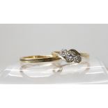 A 9ct gold and platinum three stone diamond ring on a twist, size M and a 9ct wedding ring size O1/2