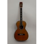 A late 19th Century American parlour guitar with spruce top, rosewood back and sides, and ornate