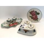 A collection of Wemyss pottery including a heart shaped inkwell, decorated with green leaves,