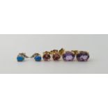 A pair of 14k gold ear studs set with pink gems, and two further pairs in yellow metal set with