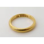 A 22ct gold wedding ring size S, weight 6.5gms Condition Report: Available upon request