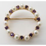 A bright yellow metal circle brooch set with amethyst and pearls, engraved verso 14k, diameter 3.