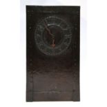 An Arts and Crafts copper clock, the hammered case with Arabic numeral dial, 33.5cm high Condition