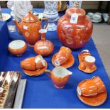 A Carlton Ware orange lustre coffee set, toastrack and condiments, a large ginger jar and a vase