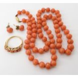 A string of coral beads, each approx 6.8mm, length 50cm, with an 18ct gold coral set ring in
