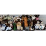 Assorted decorative ceramics including jugs, stone bottles, pottery lion with glass eyes,