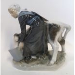 A Royal Copenhagen figure of a milkmaid and cow, no 779 Condition Report: Available upon request