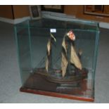 A three mast model boat in glass case, 61 x 60cm Condition Report: Available upon request