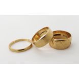 Two wide 9ct gold wedding ring sizes both O and a further 9ct wedding ring (split) size O1/2, weight