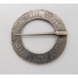 A silver Alexander Ritchie annular marriage brooch, with Glasgow hallmarks for 1928 and AR spectacle