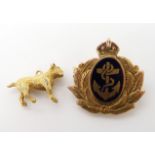 A 9ct gold and enamel Royal Navy badge and a yellow metal bull dog charm, weight combined 6gms