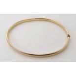 A 9ct gold bangle, weight 7.4gms Condition Report: