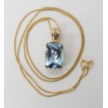 A 9ct gold checkerboard cut blue topaz and diamond accent pendant, length approx including bail 2.