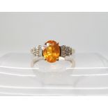 A 9ct gold fire opal and diamond ring, size M1/2, weight 2.2gms Condition Report: