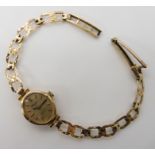 A 9ct gold ladies watch and strap, weight including mechanism 8.9gms Condition Report: Available