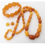 A string of amber coloured beads, weight 41.4gms, earrings 2.3gms and a bracelet weight 24.5gms