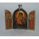 A white-metal and enamel triptych with filigree decoration, 11cm wide (open) x 9.5cm high with easel
