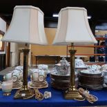 A pair of brass Corinthian column table lamps with cream shades Condition Report: Available upon