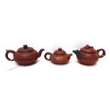 Three Yixing teapots including a compressed globular teapot, 16.5cm wide, painted teapot, 13cm