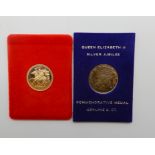 A gold full sovereign, 1979, with a 9ct commemorative medal (2.7gms) Condition Report: Available