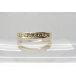 An 18ct gold diamond half eternity ring, set with estimated approx 0.50cts of princess cut diamonds,