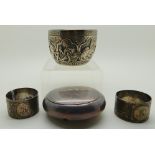 A lot comprising a Burmese white metal bowl, two napkin rings and a circular snuff box Condition