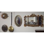 A brass Arts and Crafts oval wall mirror, sunburst clock, two wall mirrors and a bed warming pan (5)