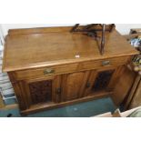An oak sideboard with carved doors Condition Report: Available upon request