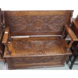 An oak monks bench with carved panels Condition Report: Available upon request