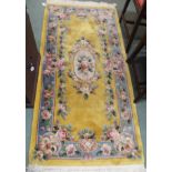 A Chinese yellow ground floral rug, 186cm x 92cm Condition Report: Available upon request