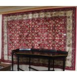 A red ground Kashmir rug with allover floral design, 116cm x 167cm Condition Report: