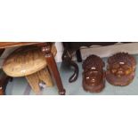 A carved occasional table and two carved face panels (3} Condition Report: Available upon request