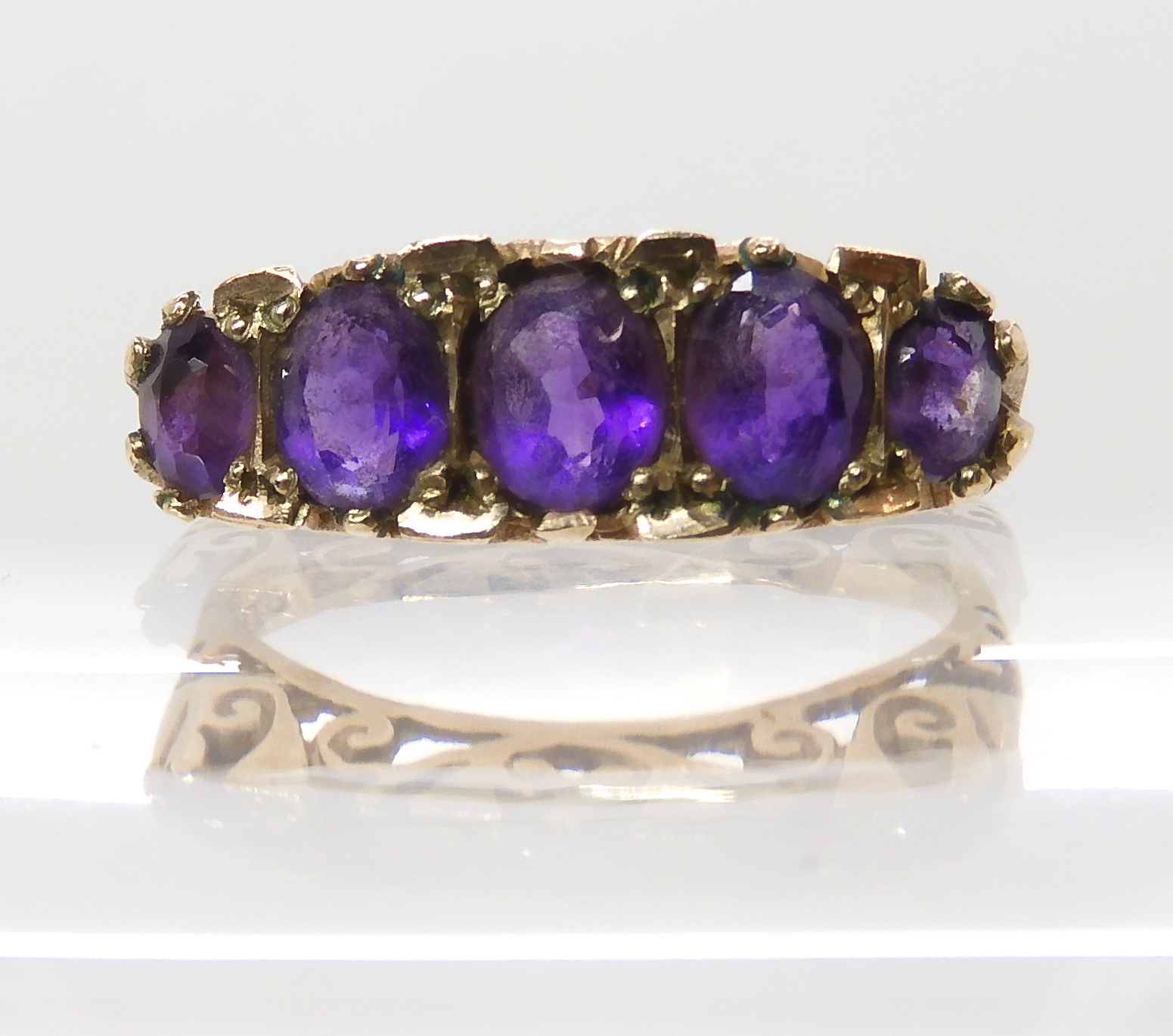 A 9ct gold five amethyst set ring, size N1/2, weight 3.2gms Condition Report: Available upon