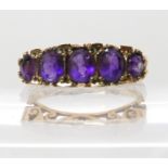 A 9ct gold five amethyst set ring, size N1/2, weight 3.2gms Condition Report: Available upon