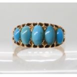 A bright yellow metal continental gold ring set with five turquoises, finger size Q, weight 3.3gms