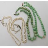 A string of green hardstone beads, a string of green glass beads with a 9ct clasp, two further