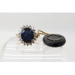 An 18ct gold sapphire and diamond cluster ring, central sapphire approx 11.4mm x 9.5mm x 5.7mm,