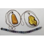 Two silver amber pendants and chains, together with a gem set silver bracelet Condition Report: