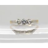An 18ct gold and platinum three stone diamond ring set with estimated approx 0.23cts of brilliant