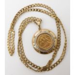 A 1902 half gold sovereign in a 9ct gold gem set pendant mount with a 9ct gold curb chain length