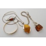 Two silver and amber pendants and chains, a silver carnelian bangle and other items Condition